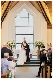 First kiss during ceremony at Beaver Creek Chapel Colorado Mountain Wedding